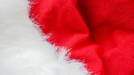 red and white fabric christmas background, red cloth and soft white furの写真素材