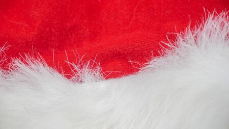 red and white fabric christmas background, red cloth and soft white fur