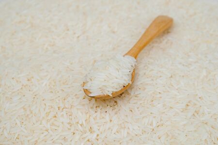 Jasmine rice and wooden spoonの写真素材