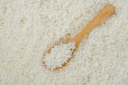 Jasmine rice and wooden spoonの写真素材