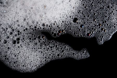 Abstract background white soapy foam texture. Shampoo foam with bubblesの写真素材