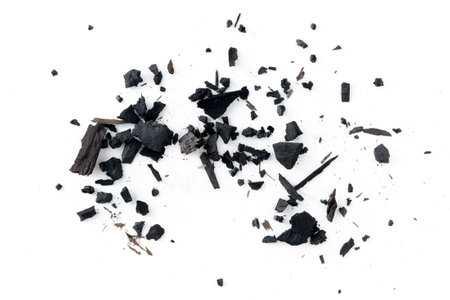 Black charcoal particles isolated on a white background, Activated charcoal powderの写真素材