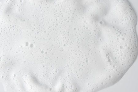 Abstract background white soapy foam texture. Shampoo foam with bubblesの写真素材