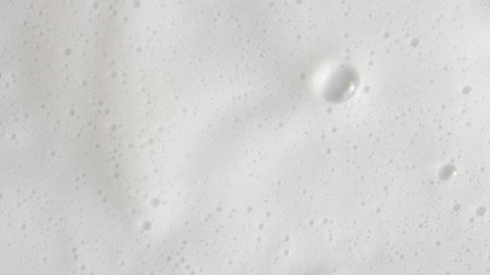 Abstract background white soapy foam texture. Shampoo foam with bubblesの写真素材