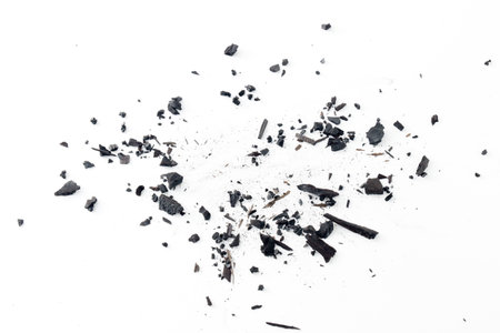Black charcoal particles isolated on a white background, Activated charcoal powder