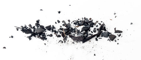 Black charcoal particles isolated on a white background, Activated charcoal powderの写真素材