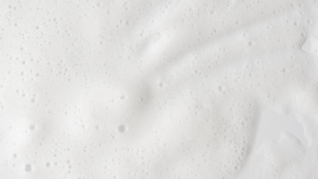 Abstract background white soapy foam texture. Shampoo foam with bubblesの写真素材