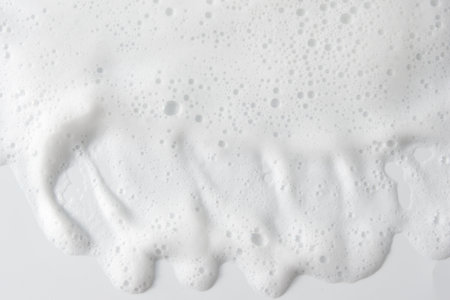Abstract background white soapy foam texture. Shampoo foam with bubblesの写真素材