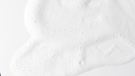 Abstract background white soapy foam texture. Shampoo foam with bubblesの写真素材