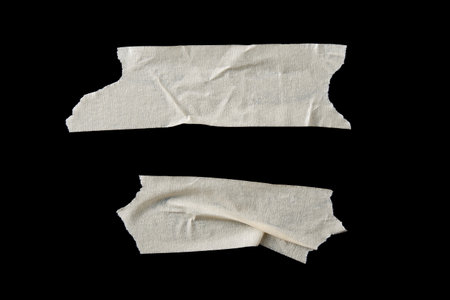 adhesive paper , masking tape isolated on black backgroundの写真素材