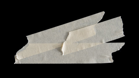 adhesive paper , masking tape isolated on black backgroundの写真素材