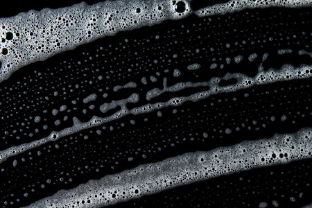 Abstract background white soapy foam texture. Shampoo foam with bubblesの写真素材