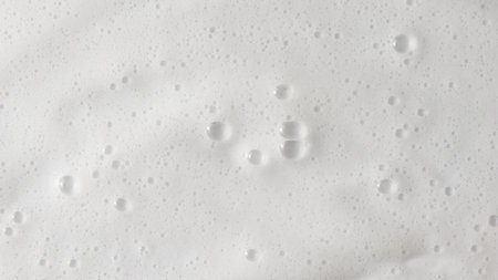 Abstract background white soapy foam texture. Shampoo foam with bubblesの写真素材