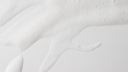 Abstract background white soapy foam texture. Shampoo foam with bubblesの写真素材