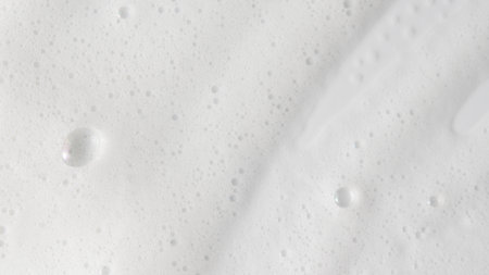 Abstract background white soapy foam texture. Shampoo foam with bubblesの写真素材