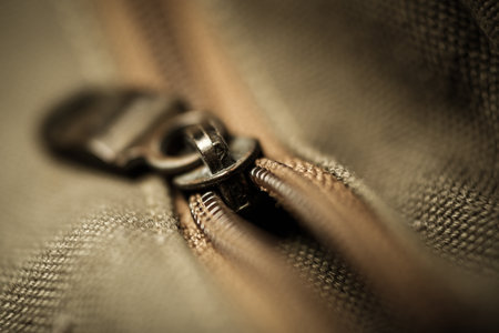 Close-up of an old zipper on a dark green clothの写真素材