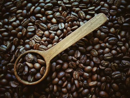 Art, vintage, coffee beans in wood spoon.の写真素材
