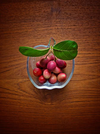 Bengal Currants (Carissa carandas L.), on woodtable, Thai fruit.の写真素材