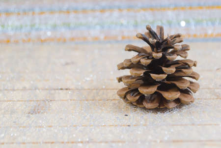 Christmas  season, decoration in home with small red ball with white dot and dry pine fruit, background wood, happy time with family.の写真素材