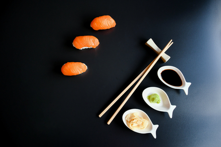 Close up top view mix sushi with various ingrediant as salmon, tuna, avocado,sesame on black background. Sushi is a deliciousJapanese dish, rice cooked with vinagre and top with fish, or vegetable .の写真素材