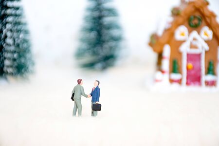 Miniature businessman shaking hand with background christmas theme, success business on holiday concept.の写真素材