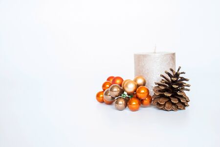 Christmas background with candles, nature pine and oragne ball on white background. Merry Ð¡hristmas greeting card and happy New Year.の写真素材