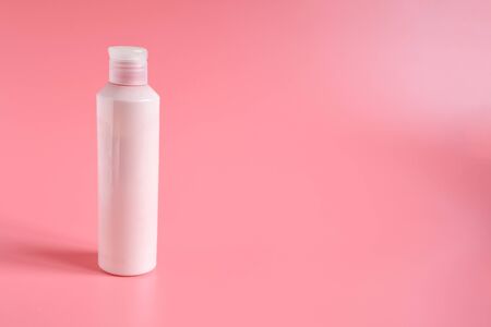 Pink plastic bottle for liquid soap  or bodylotion ,cosmetique on pink background with space for text. Health care and Buiness concept.の写真素材