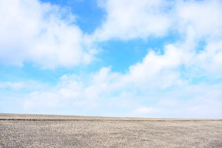 Background cement floor with beautiful nature blue sky and white white clouds. Space for textの写真素材