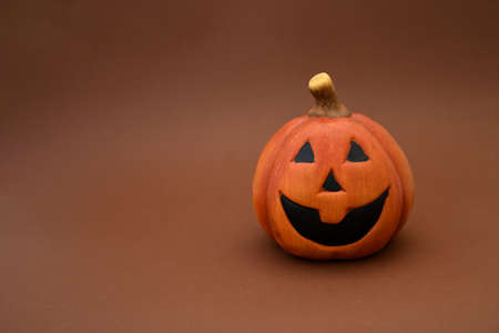 Halloween and automne background with pumpkin with big smile , on  brown background and space for write text , decorate  or inviting halloween concept.の写真素材