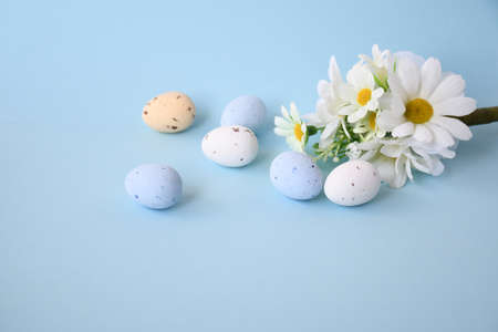 Easter background with bouquet white flwoer and easter eggs in soft color on blue sky background decorate and text copy space, happy and funny season in aprilの写真素材