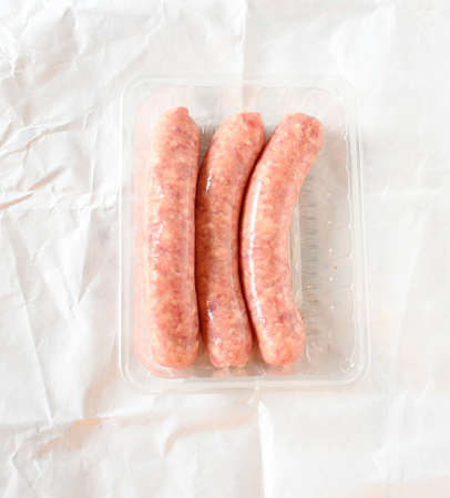 Top view fresh raw porc and beef mix sausage on white paper background .Raw food ingredient concept.の写真素材