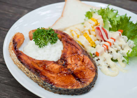 salmon steak on wood tableの写真素材
