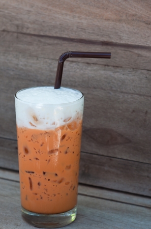 thai iced tea with milk on wood tableの写真素材
