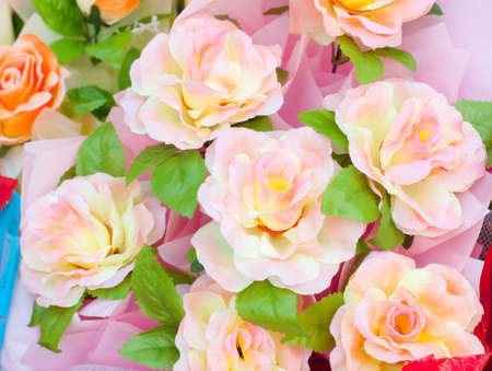 decoration artificial flowers, pink and yellow rosesの写真素材