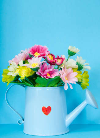 colorful flowers decoration with blue wall backgroundの写真素材