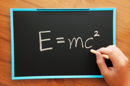 writing physical formula on chalkboard