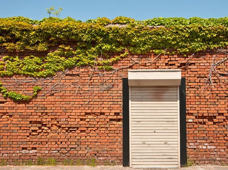 shuttered door with brick wallの写真素材