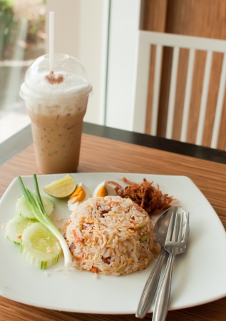 fried rice with iced coffee in restaurantの写真素材