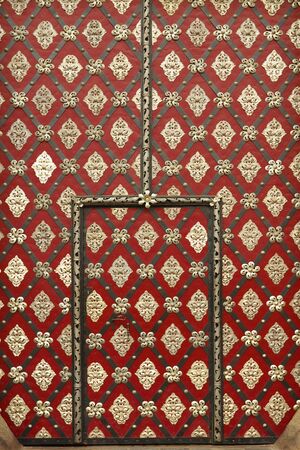 A red historical gate with ornamentsの写真素材