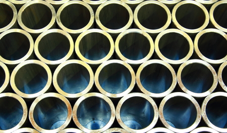 Stack of steel pipes automotive parts production industryの写真素材