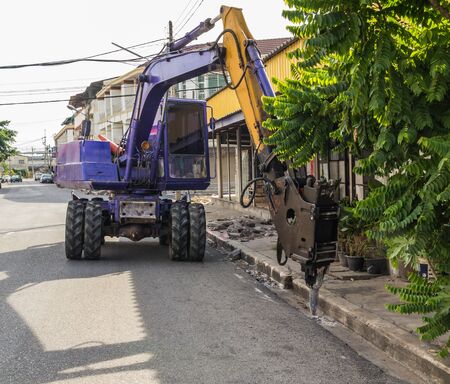 industrial backhoe, bulldozer moving drilling for road construction updates.