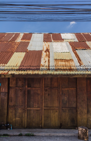 Wooden house tin roof ,Old Thai style wooden house with rusty zinc roofの写真素材