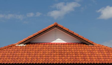 red rooftop against blue sky