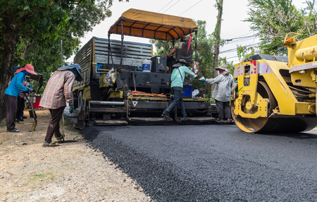 machine and worker at road construction