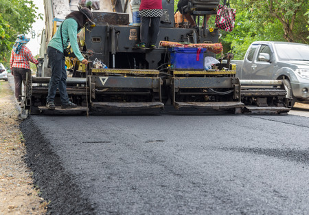 machine and worker at road constructionの写真素材