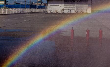 Rainbow on the field , Caused by sunlight on water.の写真素材