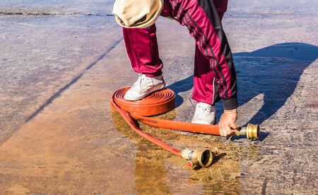 Firefighter fighting fire during trainingの写真素材