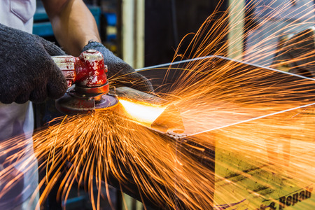 wheel grinding on steel structure in factory