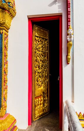 Thailand  art painting on the wall in red and gold background.の写真素材