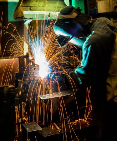 worker with protective mask welding metalの写真素材